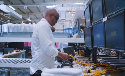 technician works on refurbishing set top box