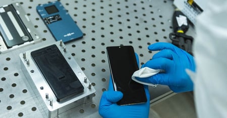 technician processes used smartphone for repair