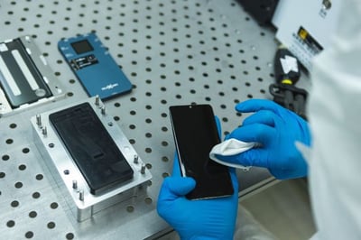 technician refurbishes used smartphone