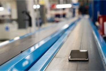 used phone on conveyor for processing