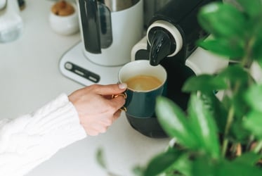 woman using coffee machine